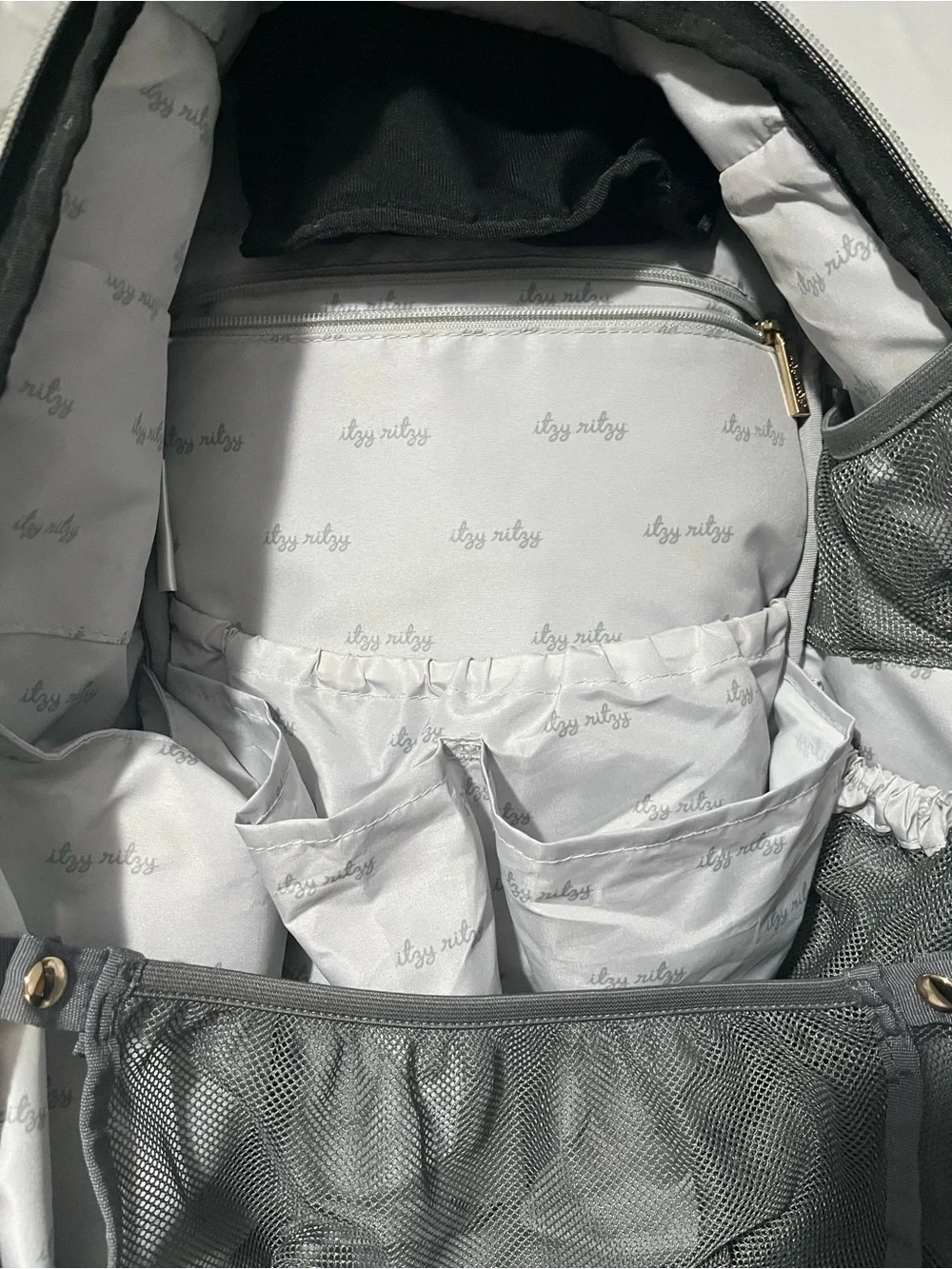 Itzy Ritzy Baby Diaper Bag Backpack in Black, White, brown with wipes case